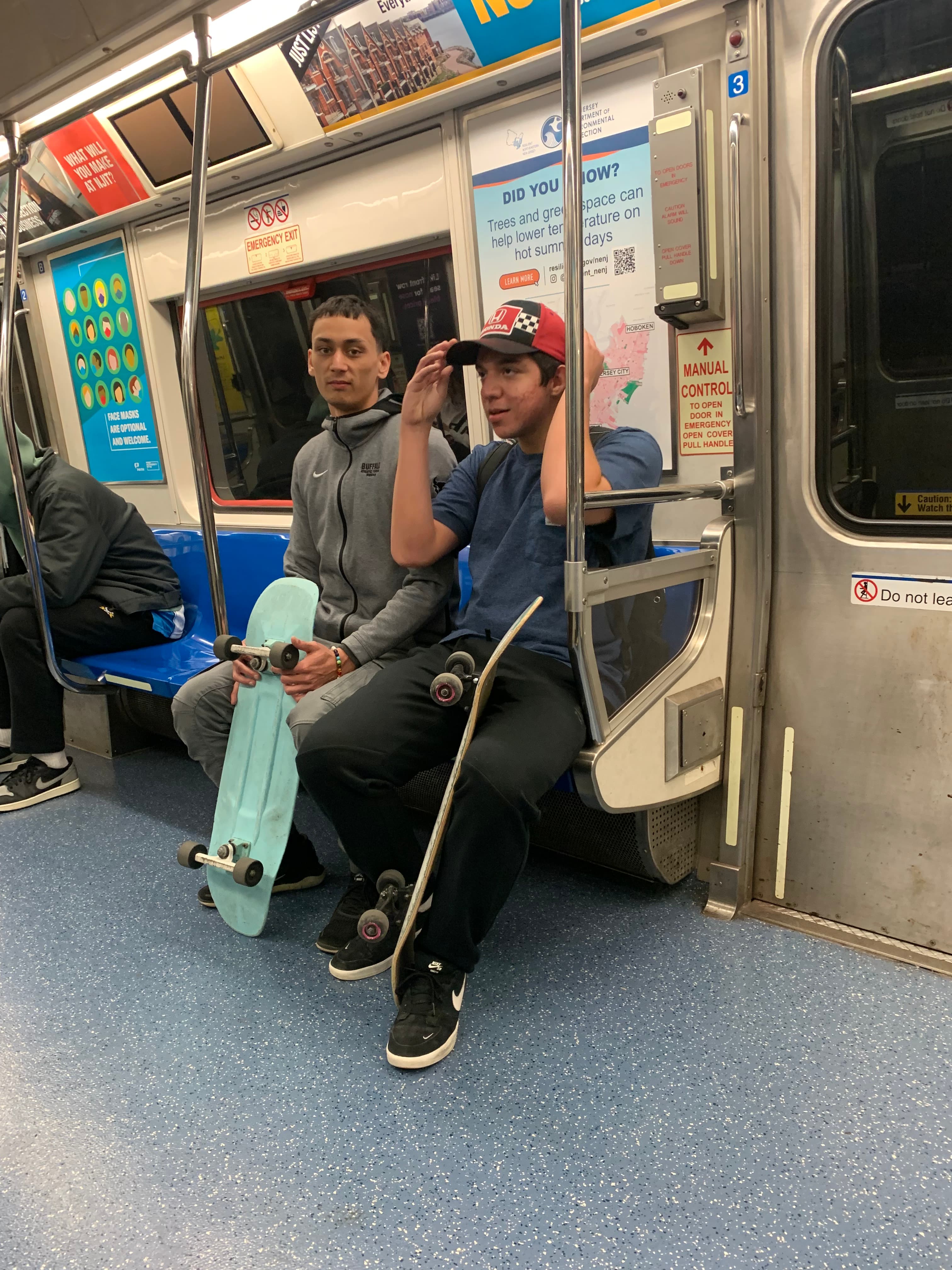 Ryan and a friend on the subway with skateboards