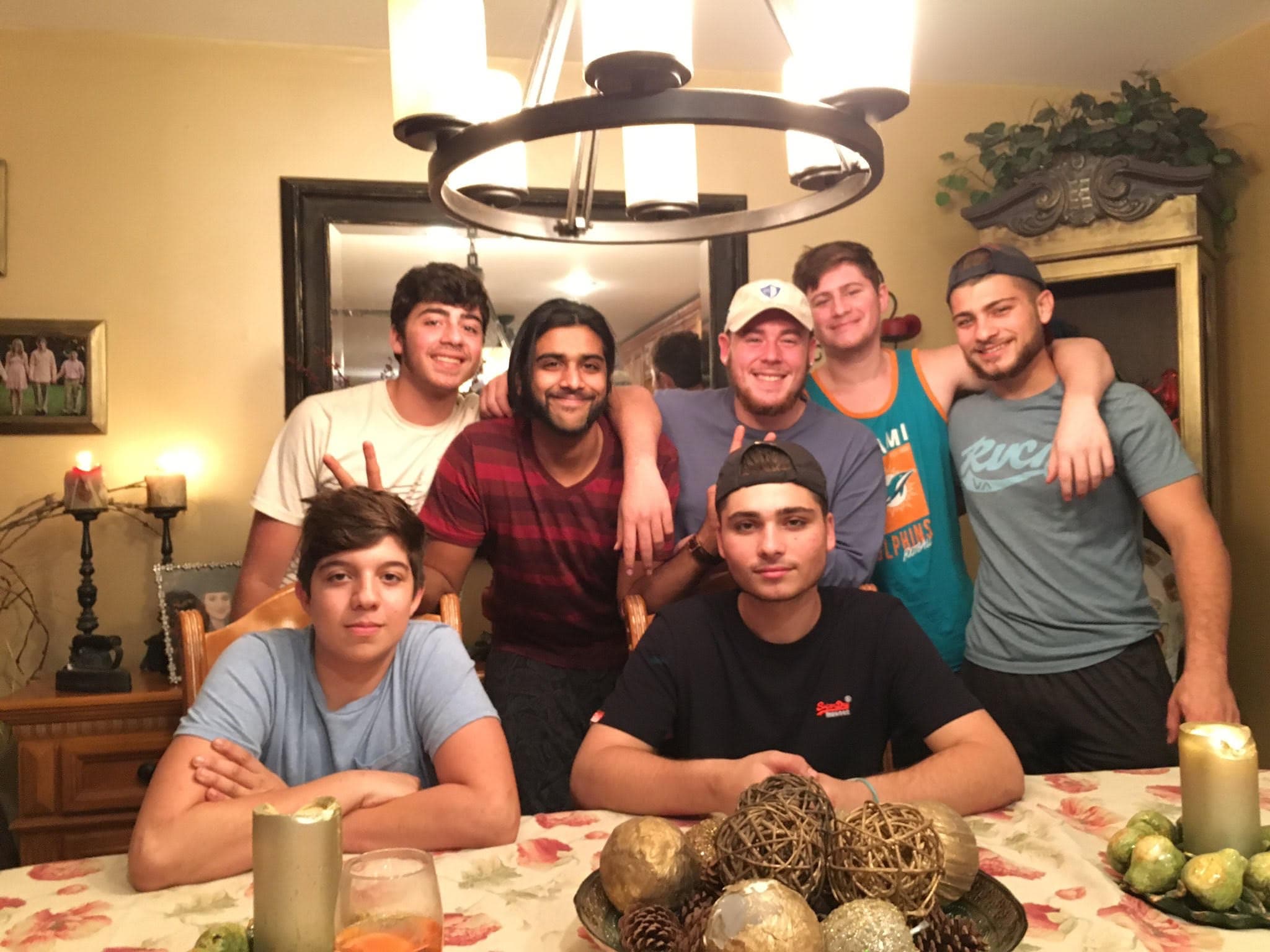 Ryan with a big group of friends around the dinner table