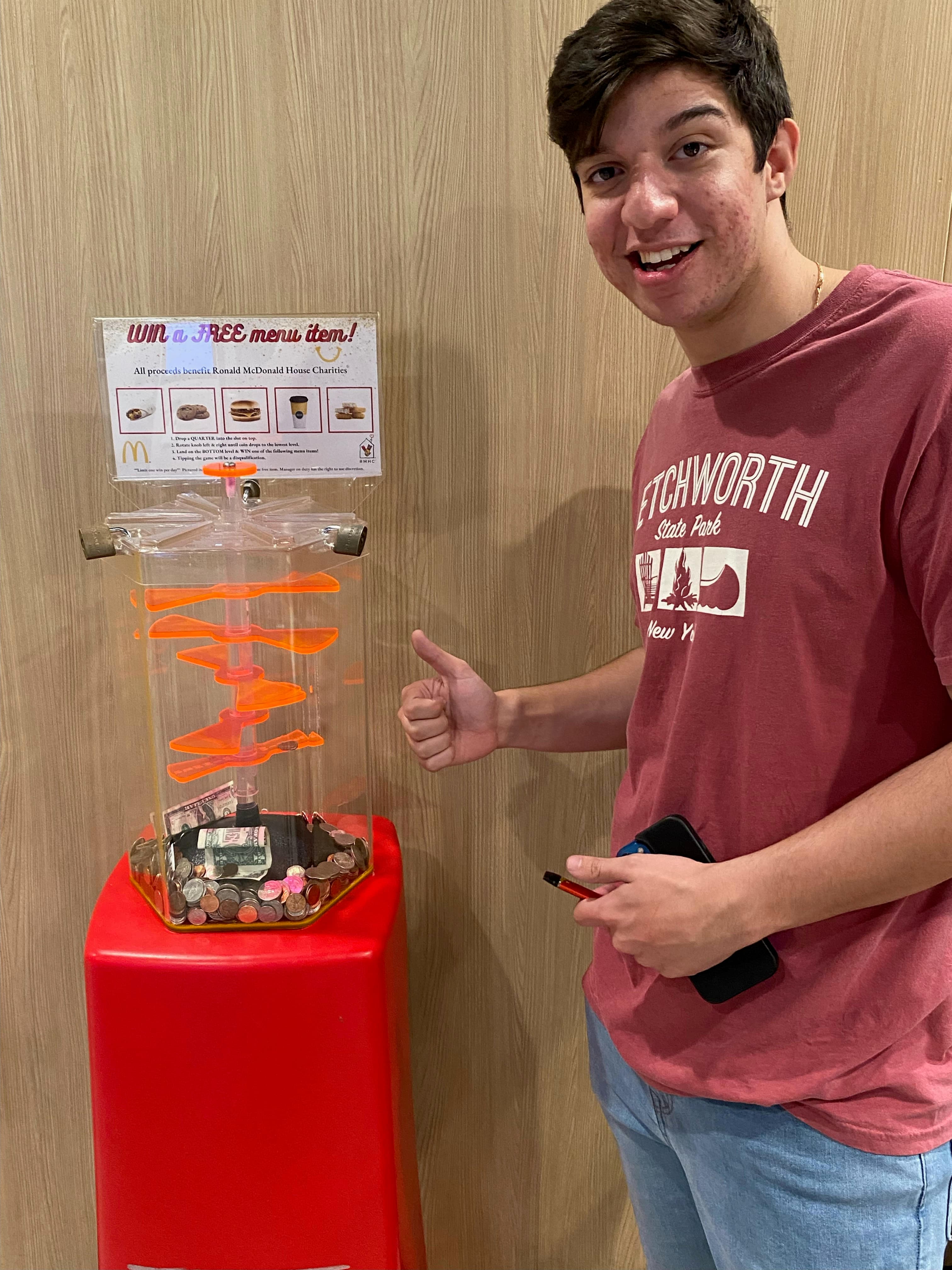 Ryan at McDonald's next to the charity coin-drop game